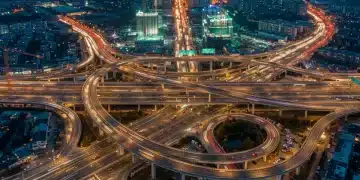 Modern highway interchange lit at dusk, symbolizing advanced infrastructure and connectivity.